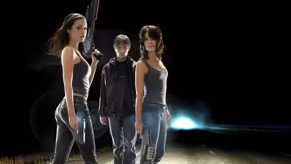 Sarah Connor with rifle beside John Connor and Cameron on dark road