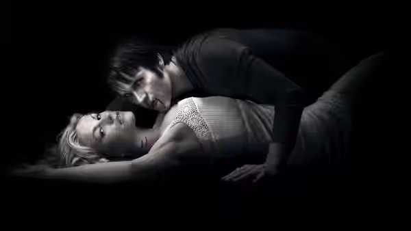 Man leaning over a blonde woman lying on the floor
