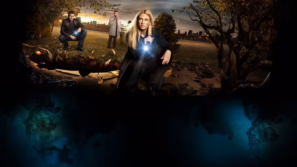 Blonde woman crouching with glowing device in park at dusk, two men behind