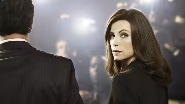 Alicia Florrick (Julianna Margulies) glancing back at a man in a suit