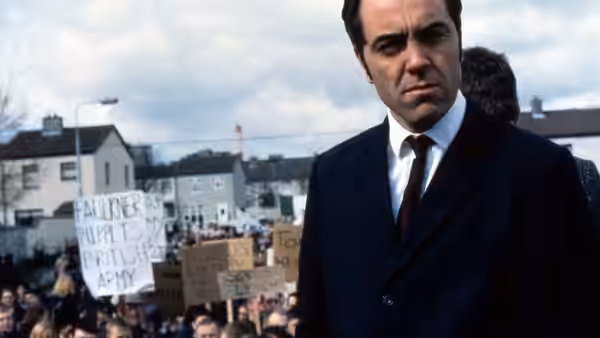 Ivan Cooper (James Nesbitt) stands before a crowd of protesters carrying anti-army signs