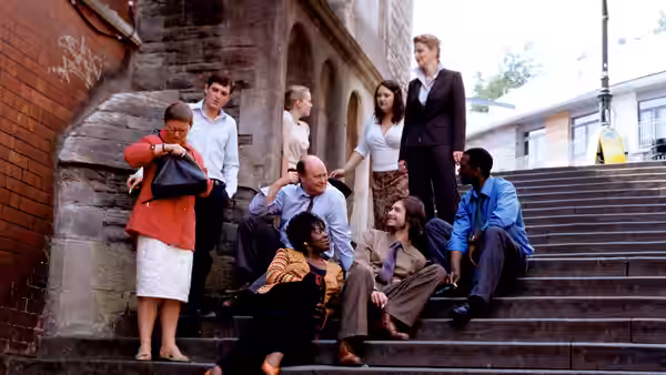 A group of people sitting and standing on outdoor stone steps
