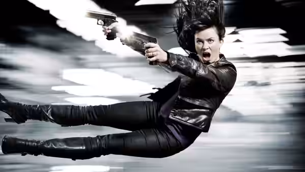 Gwen Cooper (Eve Myles) leaps through the air firing two pistols