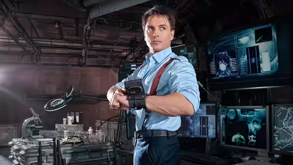 Jack Harkness (John Barrowman) checks his wrist device in a laboratory