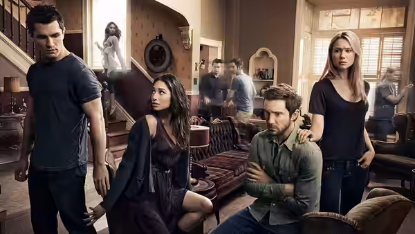Aidan Waite (Sam Witwer) standing near Sally Malik (Meaghan Rath) and Josh Levison (Sam Huntington) in living room
