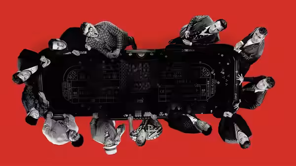 Men positioned around a poker table viewed from above on a red background