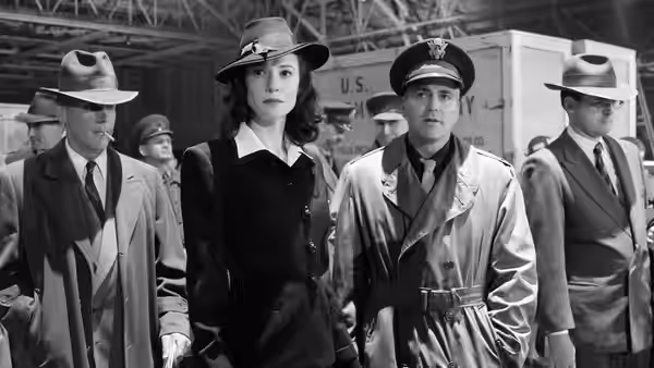 Lena Brandt (Cate Blanchett) standing with men in hats and coats indoors