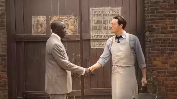 Chalky White (Michael K. Williams) shaking hands with a man in an apron
