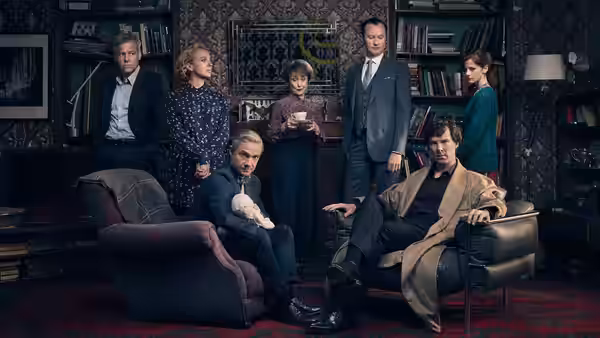 Sherlock Holmes (Benedict Cumberbatch) and John Watson (Martin Freeman) with the cast in the study