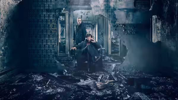 Sherlock Holmes (Benedict Cumberbatch) seated while Mycroft Holmes (Mark Gatiss) stands in ruins