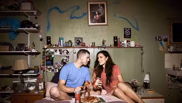 Steve (Russell Tovey) and Becky (Sarah Solemani) eating pizza and drinking in their bedroom