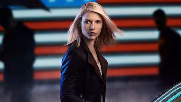 Carrie Mathison (Claire Danes) standing before a red and blue striped wall