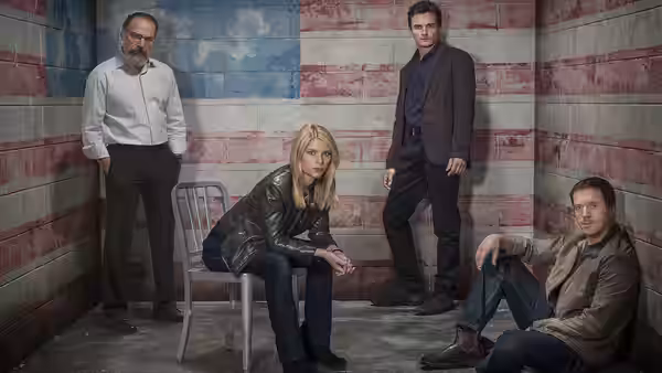 Carrie Mathison (Claire Danes) seated in a room with an American flag wall
