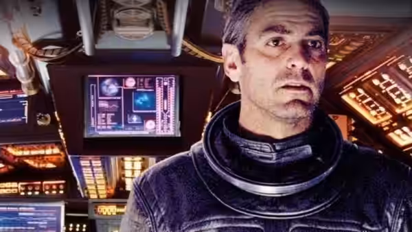 Chris Kelvin (George Clooney) in a spacesuit inside a spaceship control room
