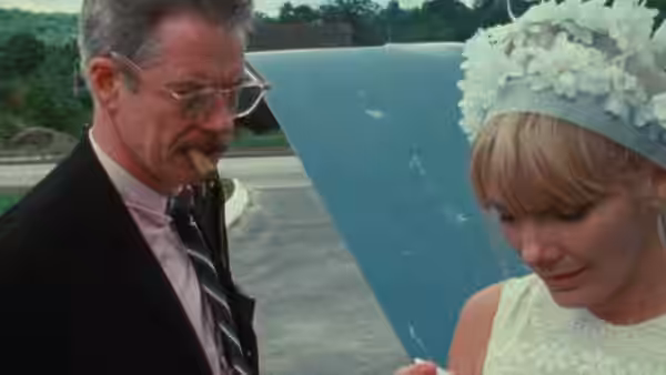 Mr. Dennis (Michael Higgins) stands beside Wanda (Barbara Loden) outdoors as she looks down