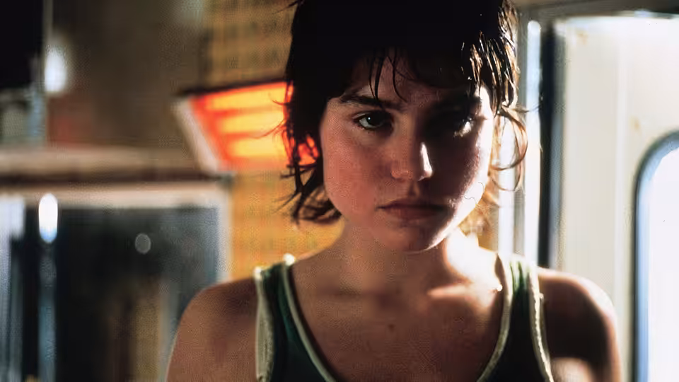 Rosetta (Émilie Dequenne) looks ahead in a dim room