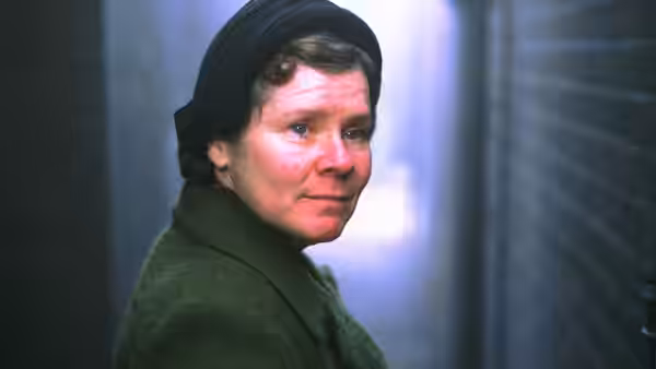 Vera Drake (Imelda Staunton) glances back in a narrow corridor