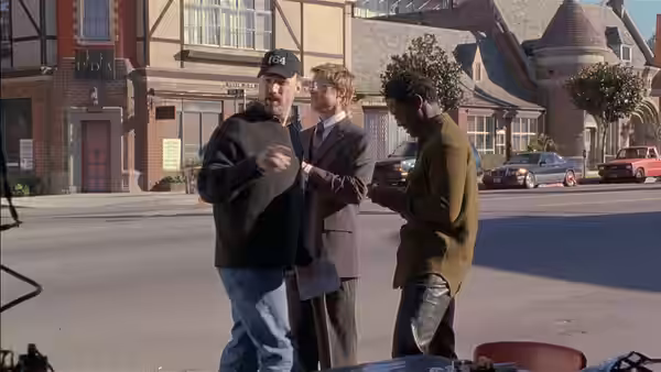 Blair Underwood with two men on a street in front of buildings