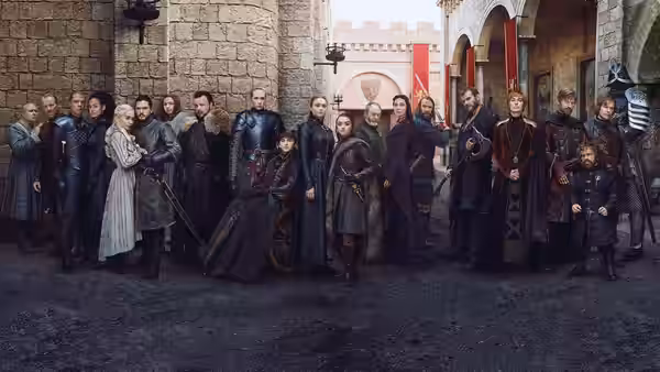 a large group of nobles and warriors assembled in a castle courtyard