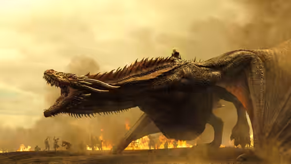 a rider atop a massive dragon flying over a burning battlefield