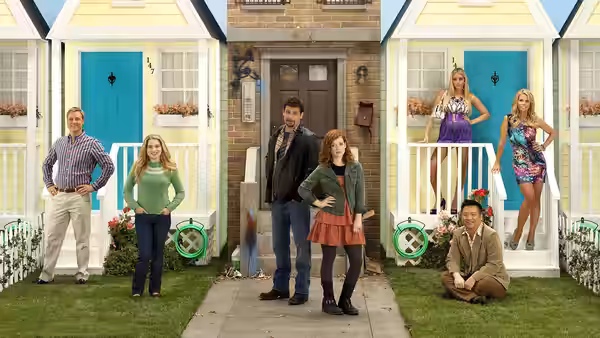 George Altman (Jeremy Sisto) and Tessa Altman (Jane Levy) stand with cast by houses