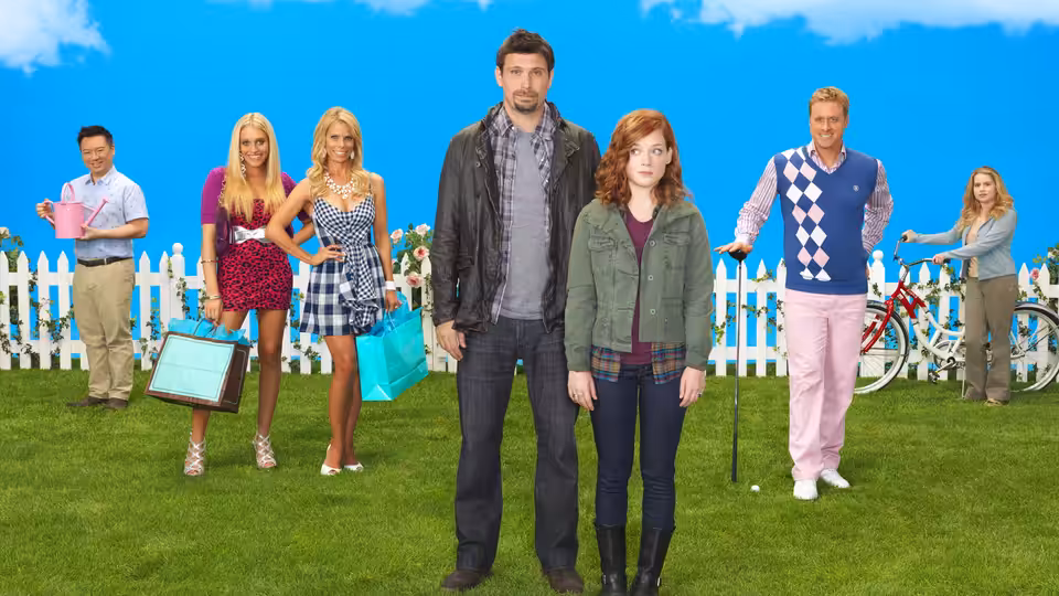 George Altman (Jeremy Sisto) and Tessa Altman (Jane Levy) stand with neighbors on a lawn