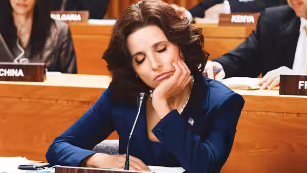 Selina Meyer (Julia Louis-Dreyfus) leans her head on her hand at the United States desk