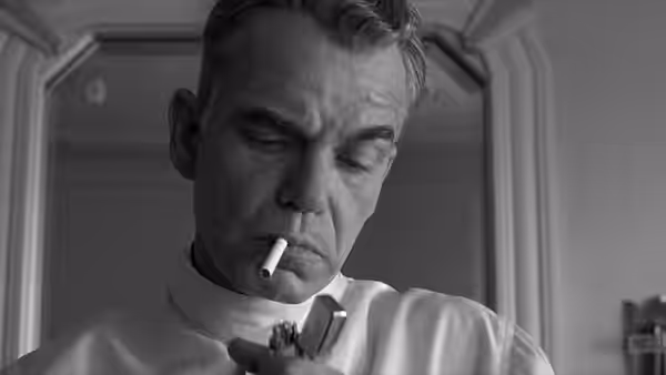 Ed Crane (Billy Bob Thornton) lighting a cigarette with a lighter