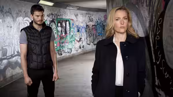 Stella Gibson and Paul Spector standing in a graffiti-covered underpass