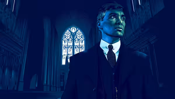 Man in a dark suit standing inside a large blue-lit church