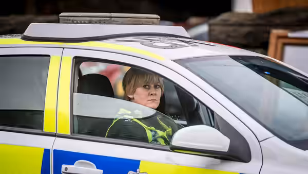 Catherine Cawood (Sarah Lancashire) sits inside a police car looking ahead