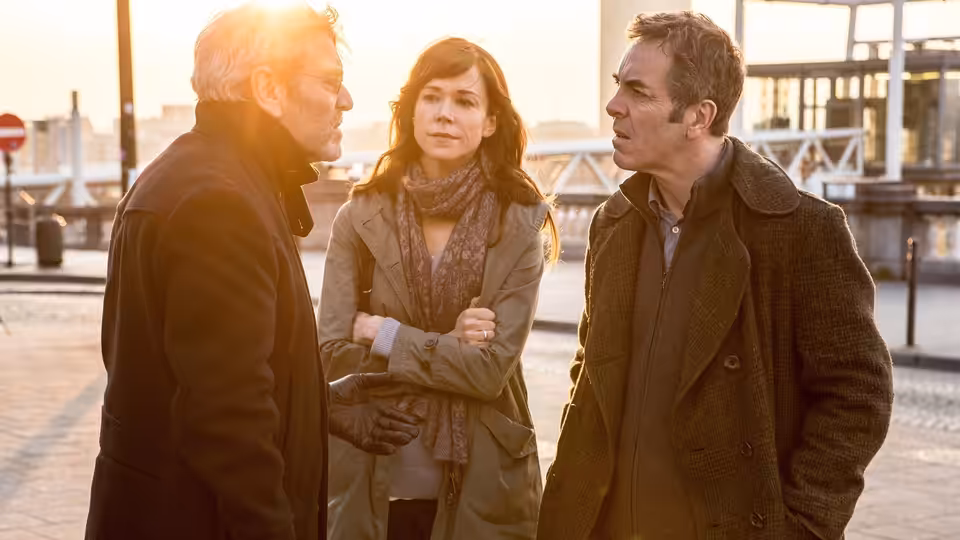 Sam Webster (David Morrissey), Gemma Webster (Keeley Hawes) and Tony Hughes (James Nesbitt) talking outdoors at dusk