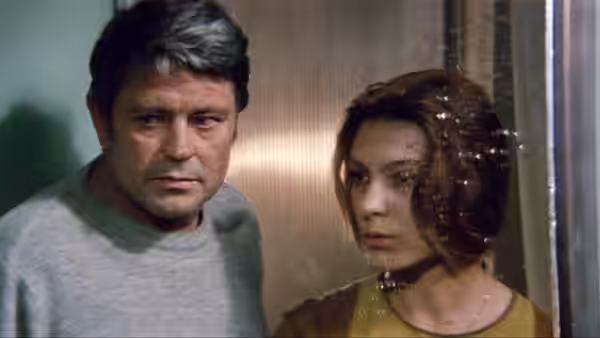 a man and woman with spots on her face stand close together