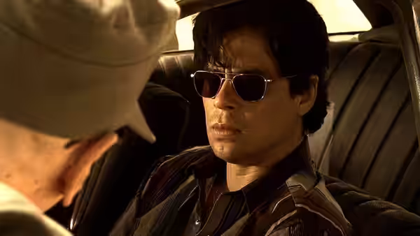 Javier Rodriguez (Benicio del Toro) seated in the back of a car