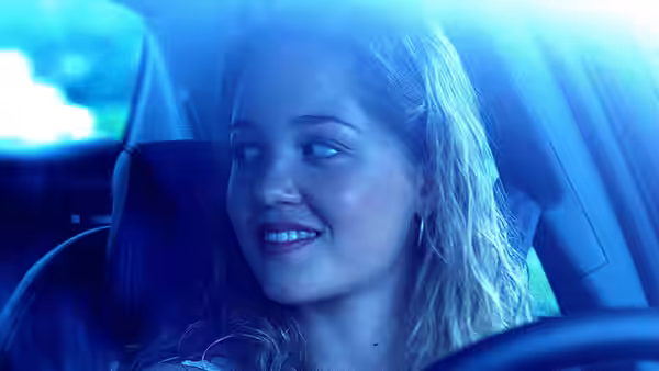 Caroline Wakefield (Erika Christensen) smiling while driving at night