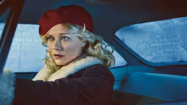Dorothy 'Dot' Lyon (Juno Temple) seated behind the wheel of a car