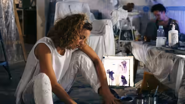 June Gudmundsdottir (Greta Scacchi) painting on the floor of her art studio