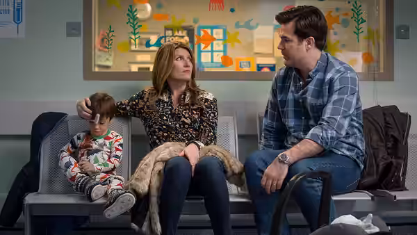 Sharon (Sharon Horgan) and Rob (Rob Delaney) with a boy on a bench