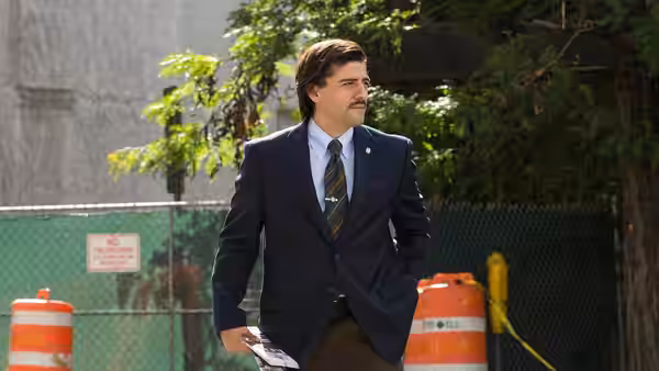 Nick Wasicsko (Oscar Isaac) walks past orange traffic barrels outdoors