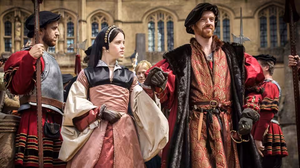 Anne Boleyn (Claire Foy) walks beside Henry VIII (Damian Lewis) outdoors