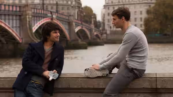 Danny (Ben Whishaw) and Alex (Edward Holcroft) talking on a riverside bridge