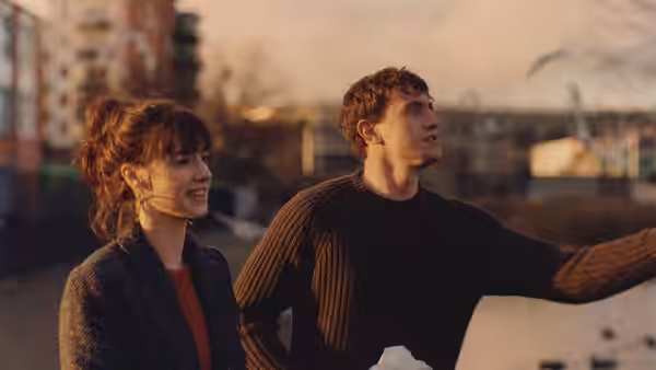 Marianne (Daisy Edgar-Jones) and Connell (Paul Mescal) standing together at dusk