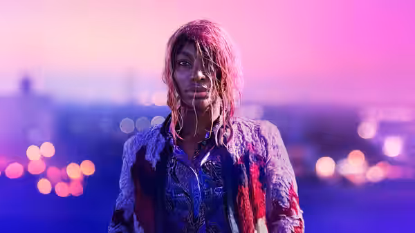 Arabella (Michaela Coel) with wet pink hair and bloodied clothes outdoors