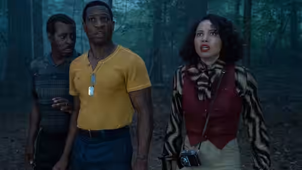 Atticus Freeman (Jonathan Majors) and Letitia Lewis (Jurnee Smollett) in a dark forest
