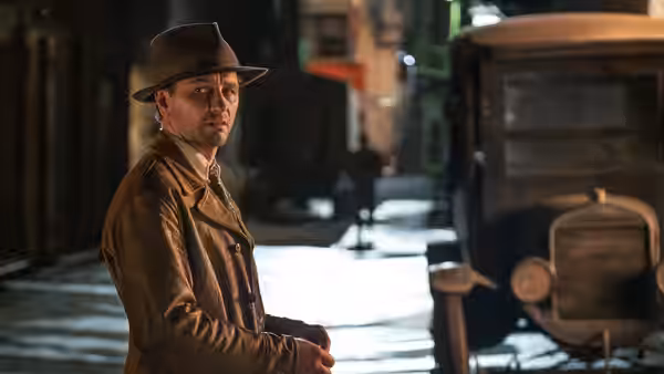 Perry Mason (Matthew Rhys) standing on a nighttime street beside a vintage car