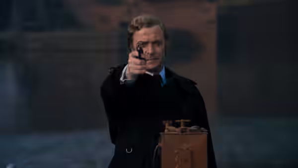 Jack Carter (Michael Caine) aiming a revolver in an industrial yard