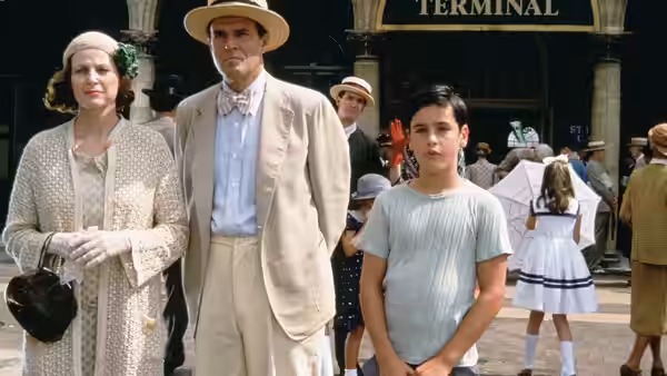 Man woman and boy stand together in front of a terminal entrance