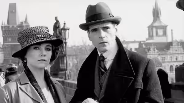 Kafka (Jeremy Irons) and Gabriela (Theresa Russell) standing on a bridge