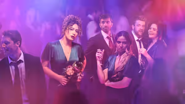 Jessie (Rose Matafeo) and Tom (Nikesh Patel) with friends at a party