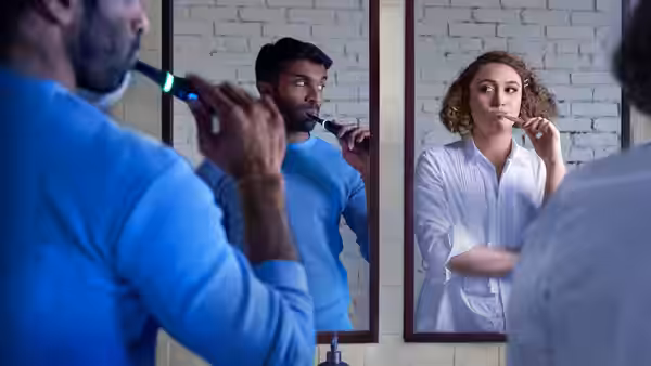 Jessie (Rose Matafeo) and Tom (Nikesh Patel) brushing teeth in a bathroom